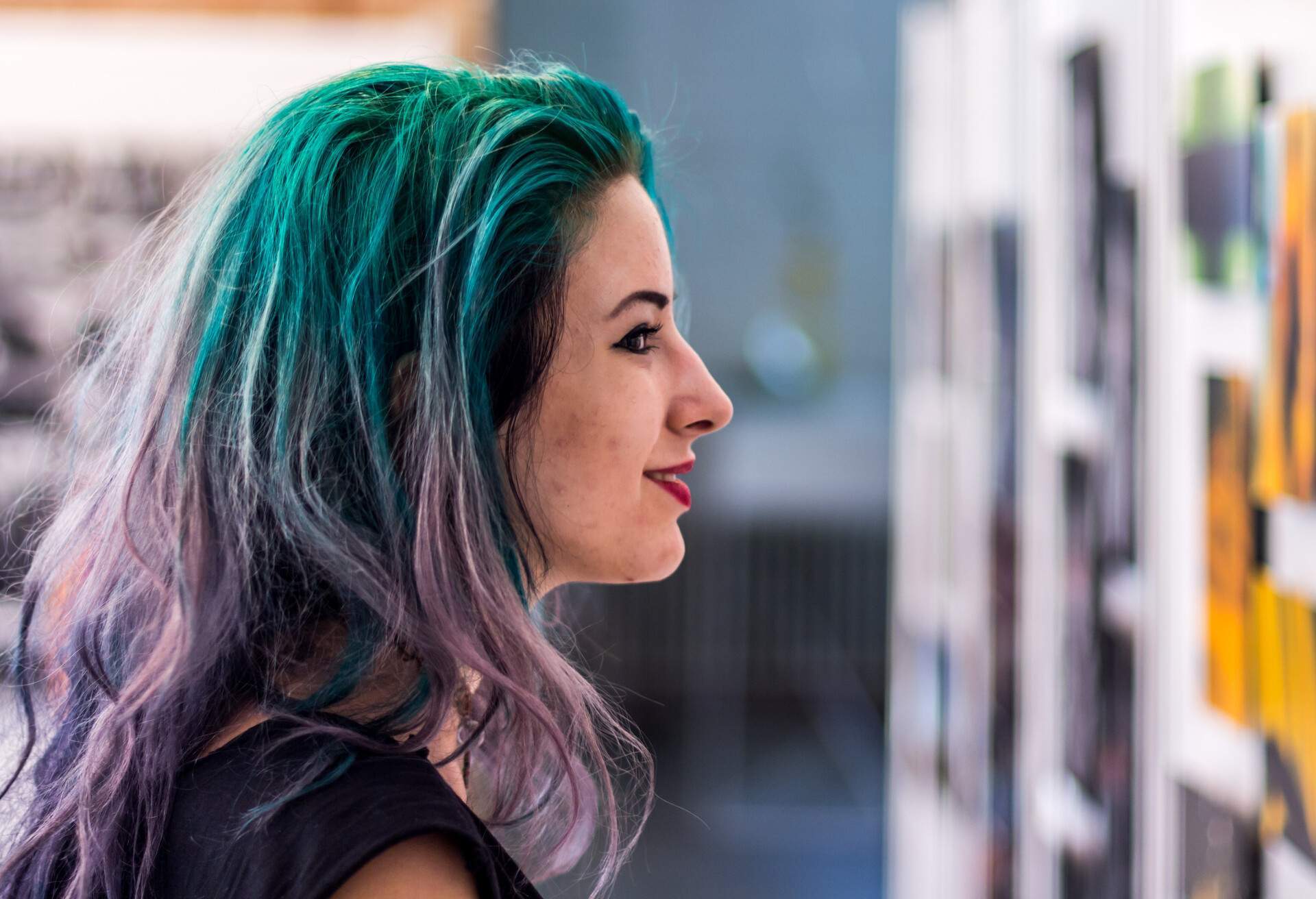 Young woman in gallery watching photos