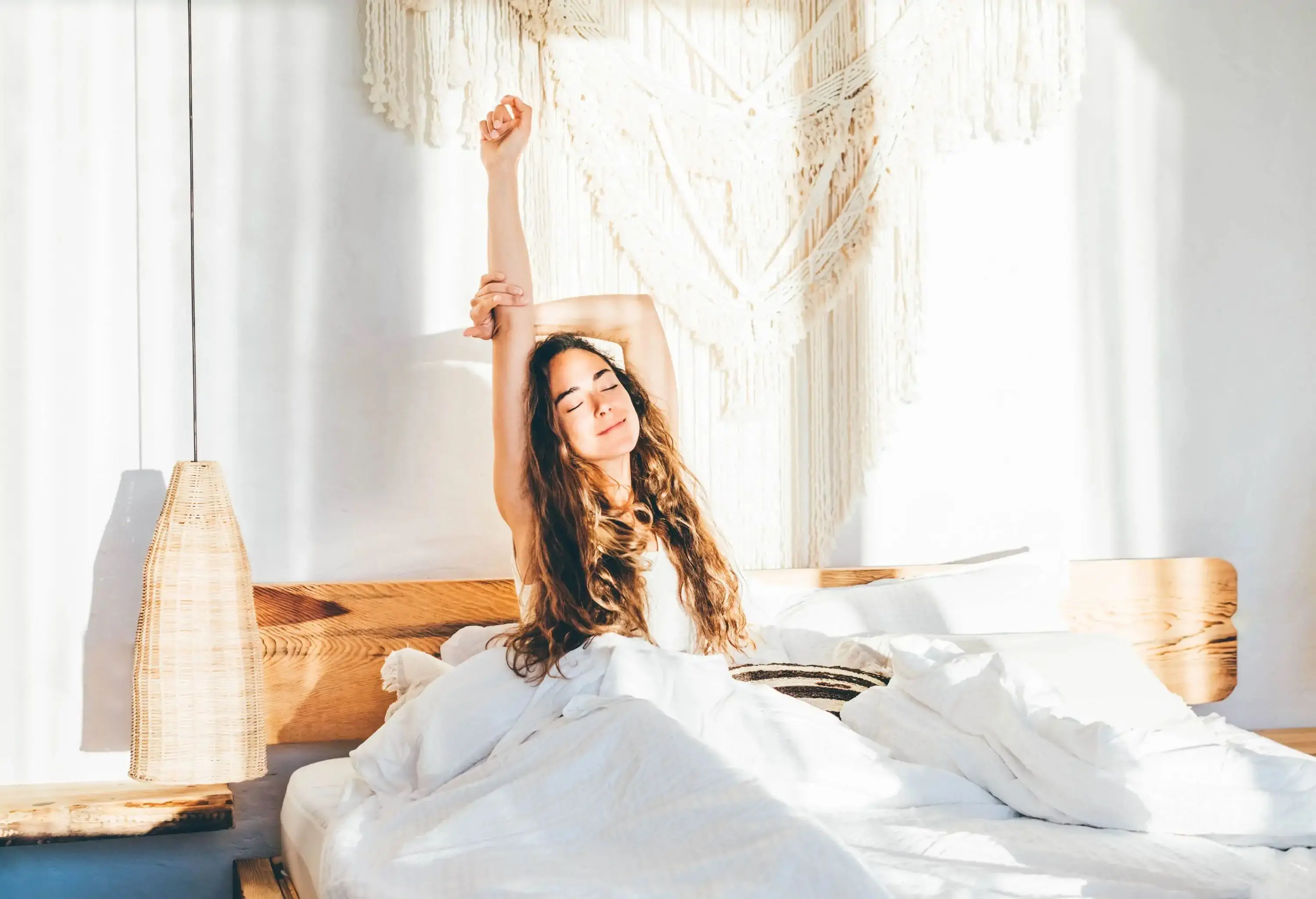 woman stretching in hotel bed