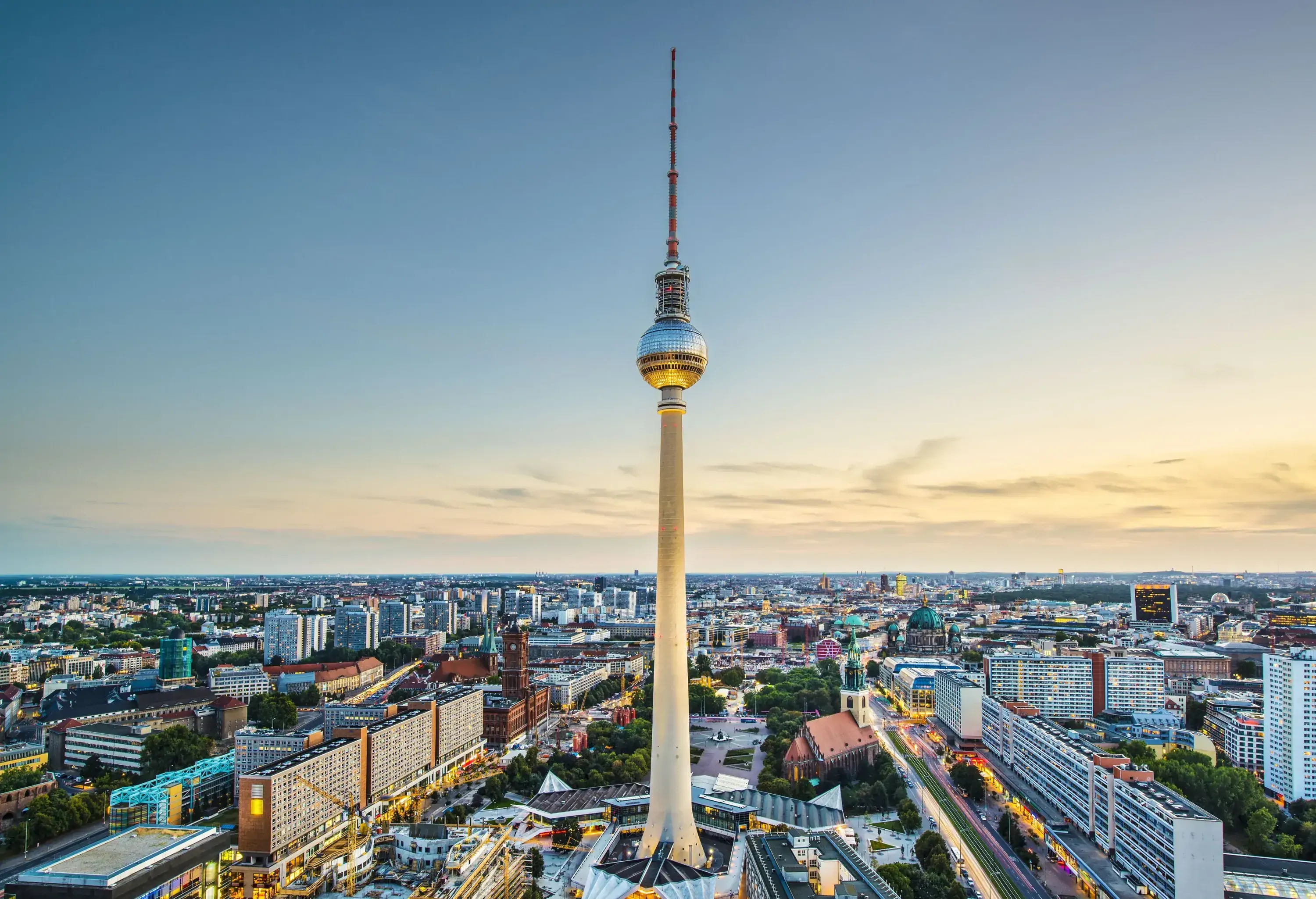 Berlin Television Tower features a spherical body and a tall antenna that is situated in the middle of a metropolis.